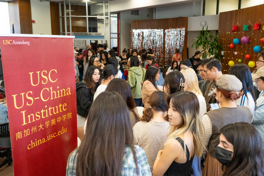 students-crowded-around-sign