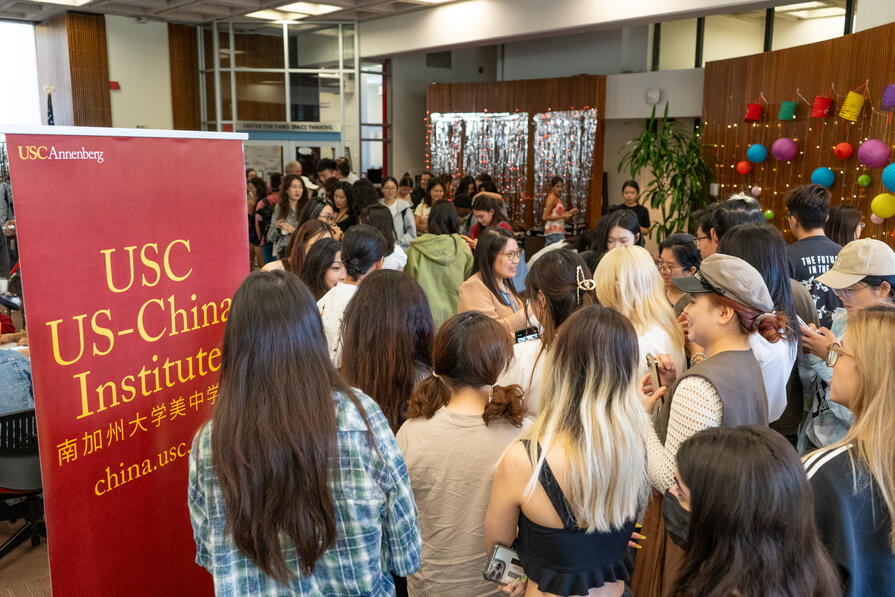 Students next to a sign at an event